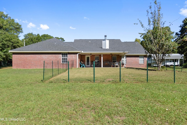 back of house featuring a lawn