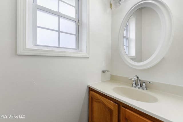 bathroom with a healthy amount of sunlight and vanity