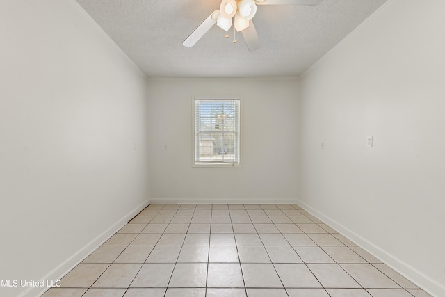 tiled spare room featuring a textured ceiling and ceiling fan