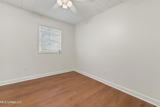 empty room with hardwood / wood-style flooring and ceiling fan