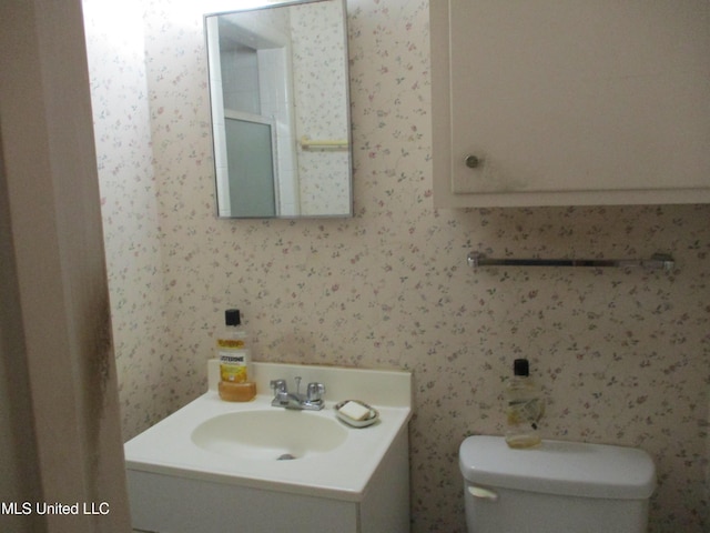 bathroom with vanity and toilet