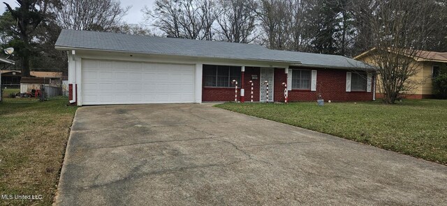 ranch-style house with a garage and a front lawn