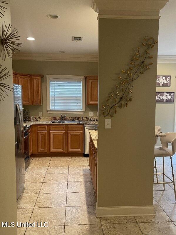 kitchen featuring sink, crown molding, dishwasher, and light stone counters