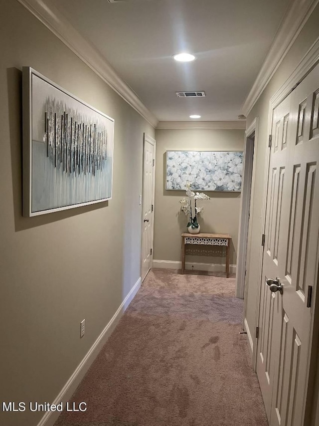 hall featuring ornamental molding and carpet flooring