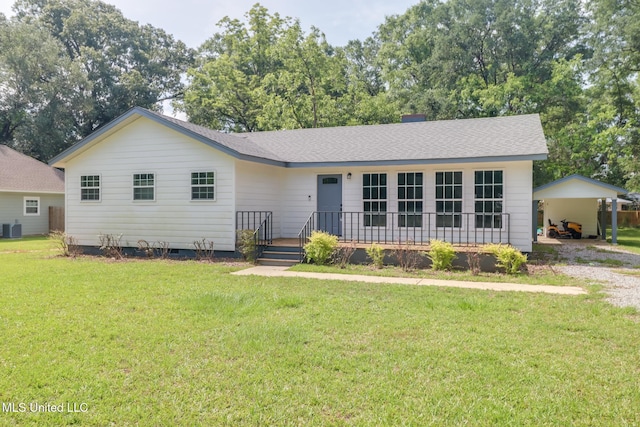 557 S Pine St, Lucedale, MS 39452 - ranch-style house with a front yard, central AC unit, a detached carport, and a shingled roof