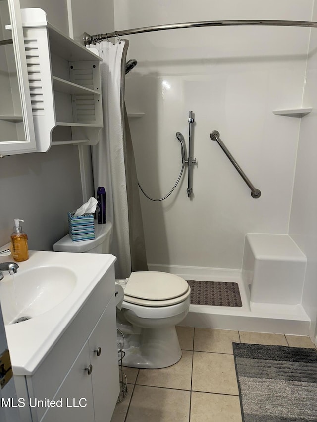 bathroom with vanity, toilet, a shower with shower curtain, and tile patterned flooring