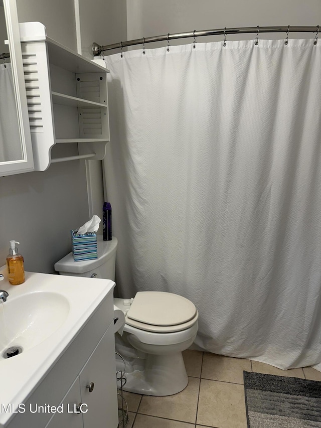 bathroom with vanity, toilet, and tile patterned flooring