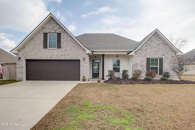 traditional home with driveway, brick siding, roof with shingles, and a front yard