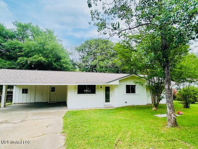 810 Louis Wilson Dr, Brandon, MS 39042 - ranch-style home featuring concrete driveway, a front yard, board and batten siding, and a carport