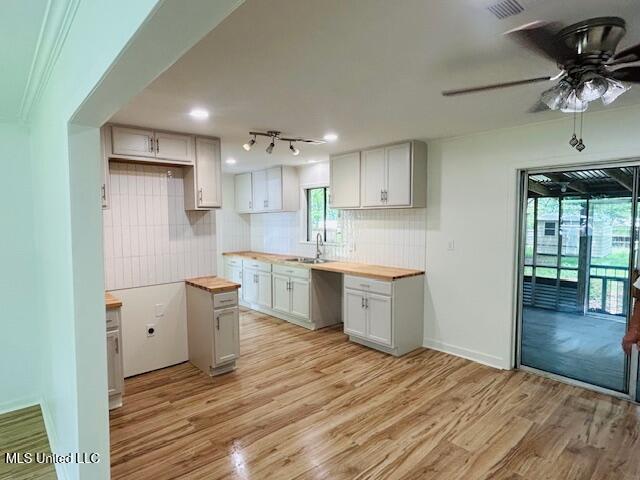 810 Louis Wilson Dr, Brandon, MS 39042 - kitchen featuring butcher block countertops, a sink, light wood-style floors, and recessed lighting