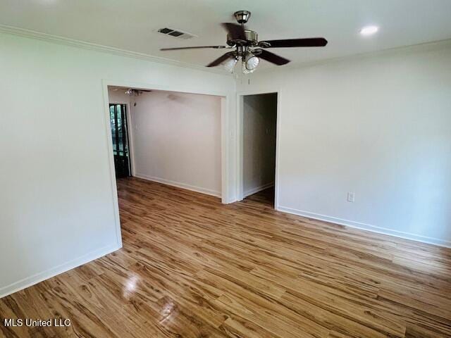 810 Louis Wilson Dr, Brandon, MS 39042 - empty room featuring a ceiling fan, wood finished floors, baseboards, and ornamental molding