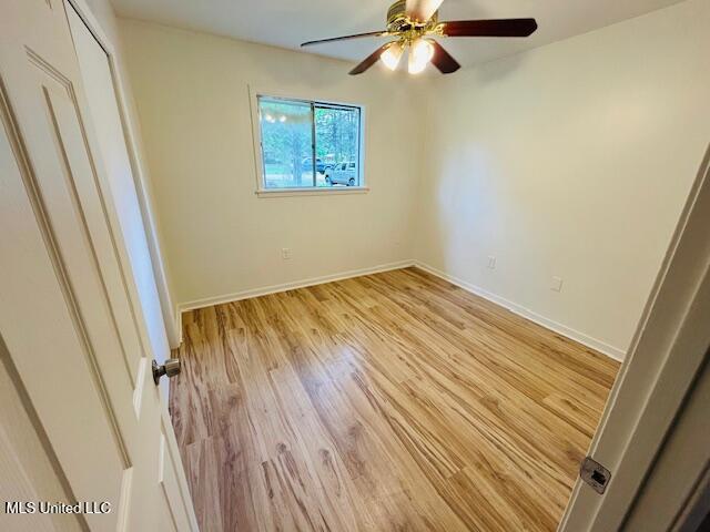 810 Louis Wilson Dr, Brandon, MS 39042 - unfurnished bedroom with light wood-style floors, baseboards, a ceiling fan, and a closet