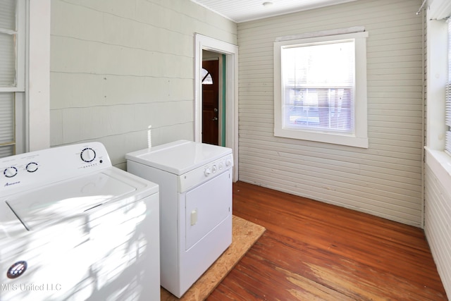 clothes washing area with washer and dryer and dark hardwood / wood-style flooring