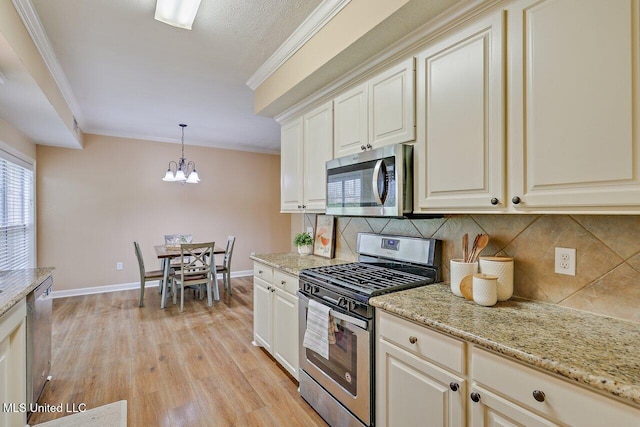 103 Cavitt Cv, Clinton, MS 39056 - kitchen with stainless steel appliances, tasteful backsplash, a chandelier, ornamental molding, and baseboards