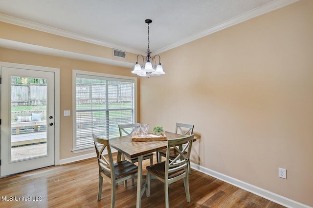 103 Cavitt Cv, Clinton, MS 39056 - dining area featuring crown molding, baseboards, wood finished floors, and a chandelier