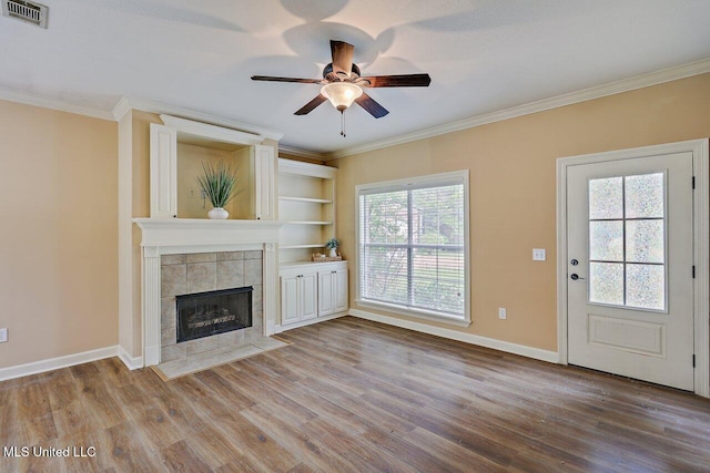 103 Cavitt Cv, Clinton, MS 39056 - unfurnished living room with ornamental molding, wood finished floors, a ceiling fan, a fireplace, and baseboards
