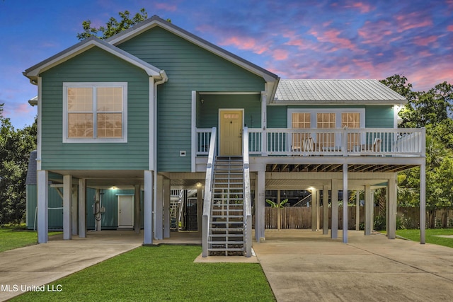 112 Vista Dr, Pass Christian, MS 39571 - beach home with a carport, driveway, stairway, covered porch, and a front yard