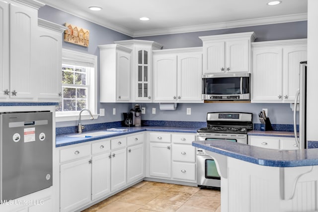 112 Vista Dr, Pass Christian, MS 39571 - kitchen featuring stainless steel appliances, white cabinets, recessed lighting, glass insert cabinets, and crown molding