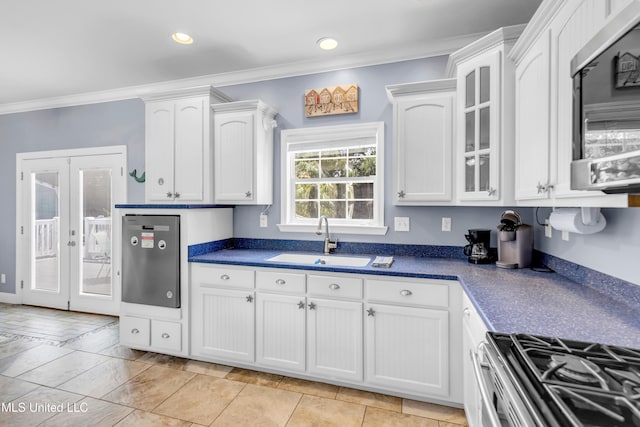 112 Vista Dr, Pass Christian, MS 39571 - kitchen with stainless steel microwave, ornamental molding, white cabinets, dark countertops, and recessed lighting