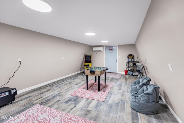 112 Vista Dr, Pass Christian, MS 39571 - recreation room with an AC wall unit and wood finished floors