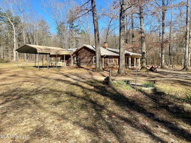 exterior space with a yard and a carport