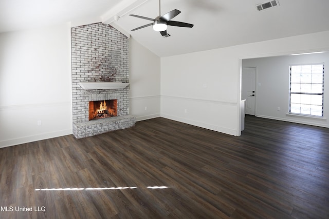 unfurnished living room with ceiling fan, dark hardwood / wood-style flooring, lofted ceiling with beams, and a fireplace