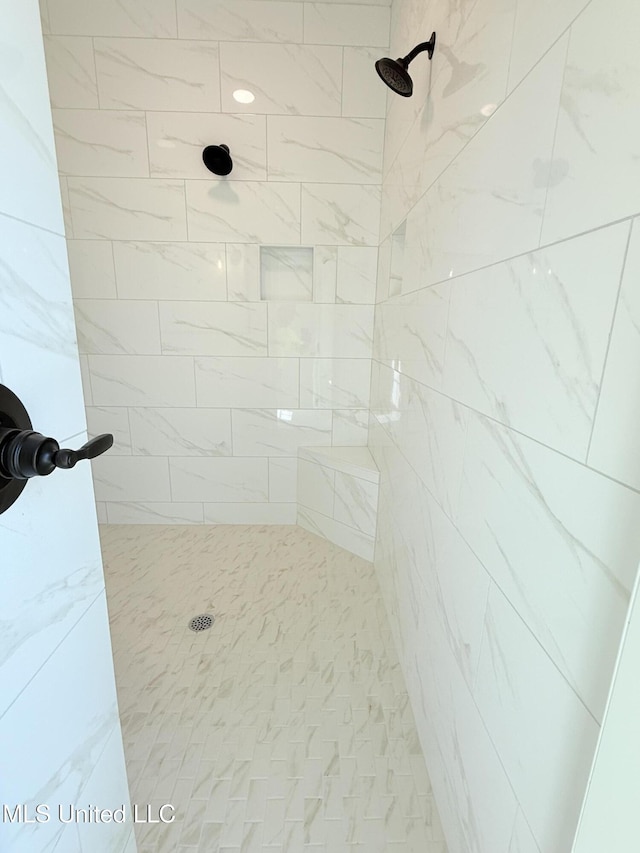 bathroom with tiled shower