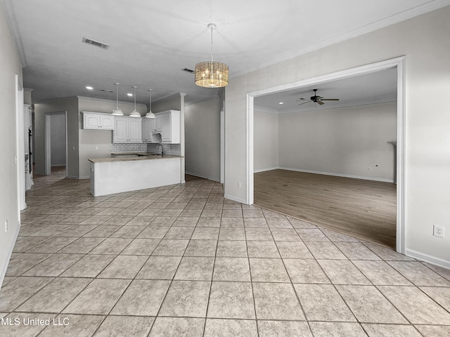 290 Geneva Blvd, Madison, MS 39110 - kitchen with open floor plan, crown molding, recessed lighting, a ceiling fan, and white cabinetry