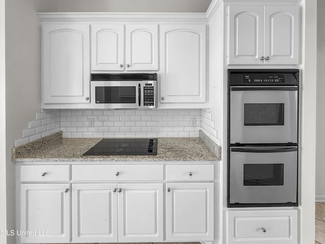 290 Geneva Blvd, Madison, MS 39110 - kitchen with appliances with stainless steel finishes, backsplash, and white cabinetry
