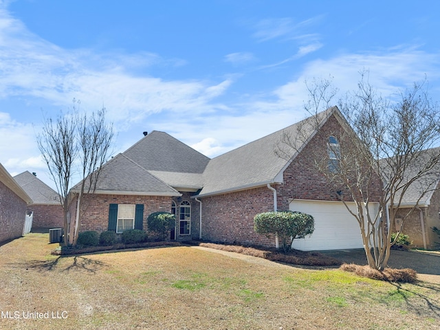 290 Geneva Blvd, Madison, MS 39110 - traditional-style house with brick siding, a shingled roof, a front yard, and an attached garage