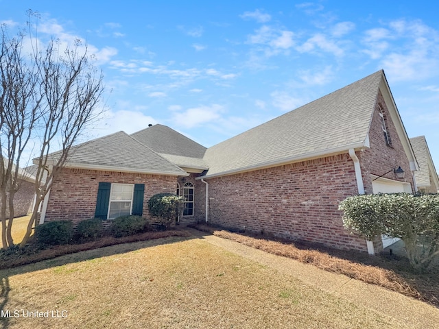 290 Geneva Blvd, Madison, MS 39110 - view of front of property with brick siding, a shingled roof, a front lawn, and a garage