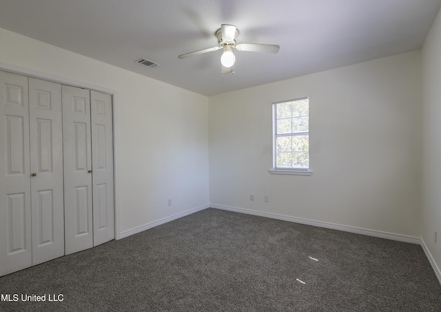 16601 Mcgregor Rd, Vancleave, MS 39565 - unfurnished bedroom featuring dark colored carpet, a closet, baseboards, and ceiling fan