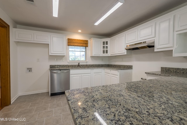 kitchen featuring dishwasher, sink, light tile patterned flooring, stone counters, and white cabinetry