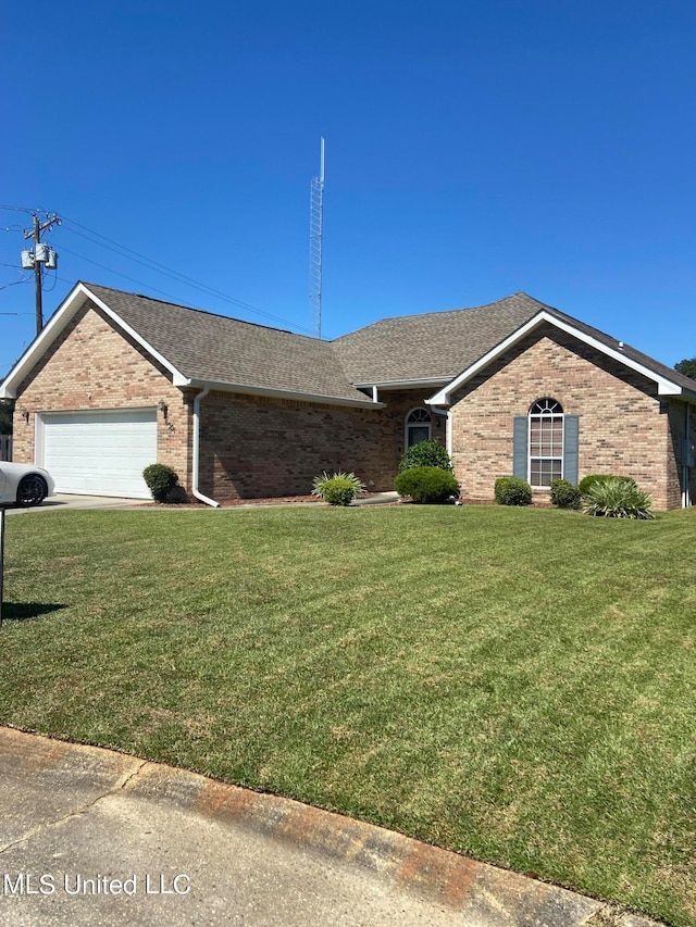 ranch-style house featuring a front yard and a garage