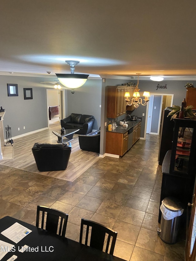 6301 W Wimbledon Cv, Ocean Springs, MS 39564 - living area featuring baseboards, ornamental molding, stone finish flooring, and a notable chandelier