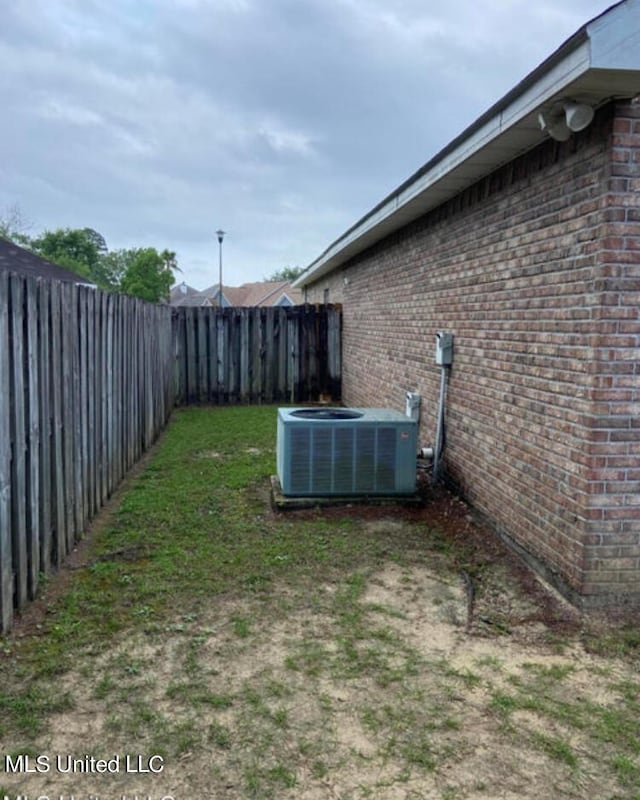 view of yard featuring central air condition unit