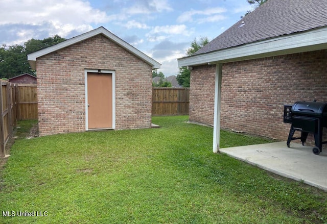 view of yard with an outbuilding and a patio