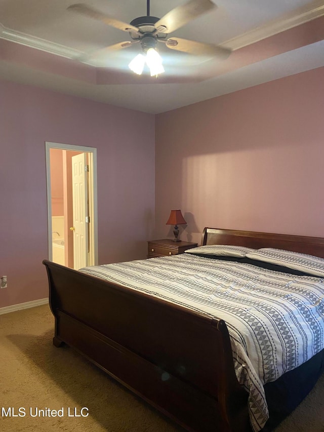 carpeted bedroom with crown molding, ensuite bathroom, and ceiling fan