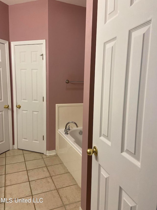 bathroom featuring tiled bath and tile patterned floors