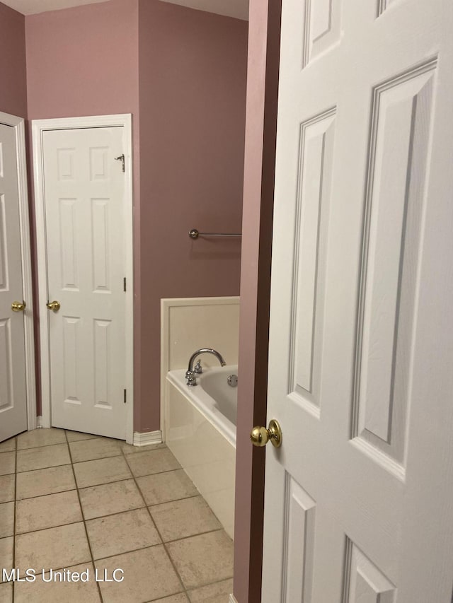 6301 W Wimbledon Cv, Ocean Springs, MS 39564 - bathroom featuring a bath, baseboards, and tile patterned flooring