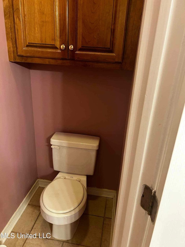 bathroom featuring toilet and tile patterned flooring