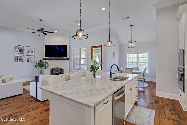 1235 Cutter Ln, Brandon, MS 39047 - kitchen featuring stainless steel appliances, open floor plan, white cabinets, light stone countertops, and dark wood-style flooring