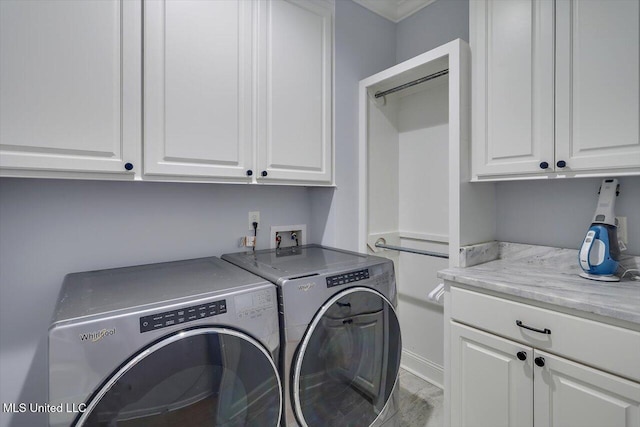 1235 Cutter Ln, Brandon, MS 39047 - laundry area featuring cabinet space and washing machine and clothes dryer