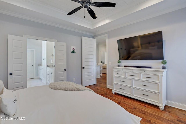 1235 Cutter Ln, Brandon, MS 39047 - bedroom featuring crown molding, a tray ceiling, wood finished floors, connected bathroom, and ceiling fan