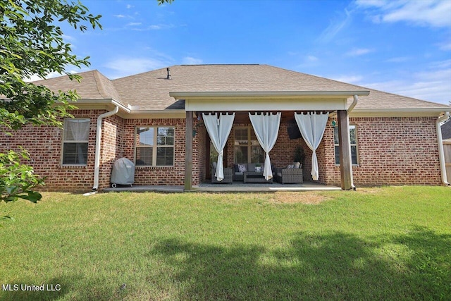1235 Cutter Ln, Brandon, MS 39047 - rear view of house with brick siding, a patio area, roof with shingles, and a yard