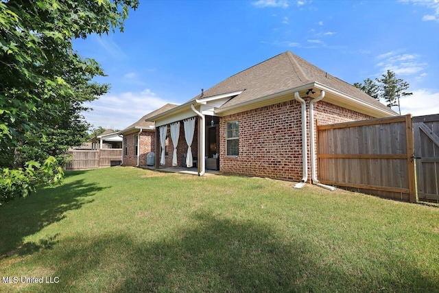 1235 Cutter Ln, Brandon, MS 39047 - rear view of property featuring brick siding, a fenced backyard, and roof with shingles