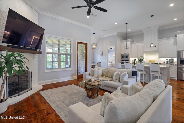 1235 Cutter Ln, Brandon, MS 39047 - living area with ceiling fan, ornamental molding, recessed lighting, dark wood-type flooring, and a brick fireplace
