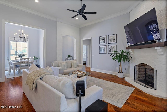 1235 Cutter Ln, Brandon, MS 39047 - living room with a chandelier, a brick fireplace, dark wood-style floors, recessed lighting, and ceiling fan