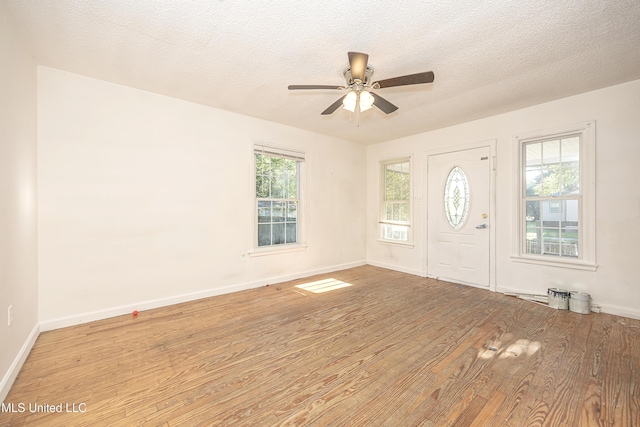 2411 12th St, Pascagoula, MS 39567 - foyer with wood finished floors, ceiling fan, and a textured ceiling