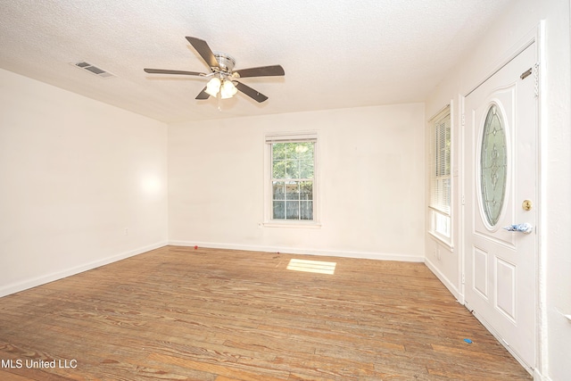 2411 12th St, Pascagoula, MS 39567 - foyer featuring light wood-style flooring, a ceiling fan, and a textured ceiling